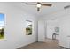 This bedroom features a ceiling fan and luxury vinyl tile flooring at 200 Snowy Orchid Way, Lake Alfred, FL 33850