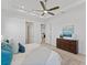Relaxing main bedroom with a tray ceiling, ceiling fan, and view into the ensuite bath at 200 Snowy Orchid Way, Lake Alfred, FL 33850