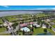 Aerial view of a community center with pools, tennis courts, and manicured landscaping at 200 Snowy Orchid Way, Lake Alfred, FL 33850