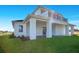 Charming exterior showing a modern two-story house with a balcony and a well-manicured lawn at 200 Snowy Orchid Way, Lake Alfred, FL 33850