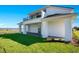 Stunning exterior view of a two-story home featuring a balcony and lush, green landscaping at 200 Snowy Orchid Way, Lake Alfred, FL 33850