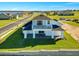 Rear exterior view showcasing the home's architecture, balcony, and expansive green lawn at 200 Snowy Orchid Way, Lake Alfred, FL 33850