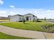 Well-maintained home with a two-car garage, pristine lawn, and modern design elements at 200 Snowy Orchid Way, Lake Alfred, FL 33850