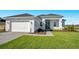 Beautiful single-story home with a white exterior, well-kept lawn, and a two-car garage at 200 Snowy Orchid Way, Lake Alfred, FL 33850