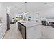 Open concept kitchen with stainless appliances, a large island, and easy access to the dining and living areas at 200 Snowy Orchid Way, Lake Alfred, FL 33850