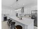 Modern kitchen with stainless steel appliances, a large center island, and sleek white cabinetry at 200 Snowy Orchid Way, Lake Alfred, FL 33850