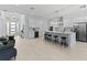 Modern kitchen with white cabinetry, a large island with seating, and stainless steel appliances at 200 Snowy Orchid Way, Lake Alfred, FL 33850