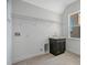 Bright laundry room features tile floors, sink with cabinet, and convenient wall shelving at 200 Snowy Orchid Way, Lake Alfred, FL 33850