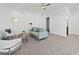Bright living room with modern gray sofa, neutral decor and ceiling fan at 200 Snowy Orchid Way, Lake Alfred, FL 33850