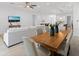 Open concept living space with a modern dining table and a comfortable sofa at 200 Snowy Orchid Way, Lake Alfred, FL 33850