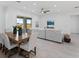 Open-concept living and dining area with a dining table, comfortable sofa, and natural light at 200 Snowy Orchid Way, Lake Alfred, FL 33850