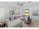 Comfortable living room with a sectional sofa, wood coffee table, and access to the outdoors at 200 Snowy Orchid Way, Lake Alfred, FL 33850