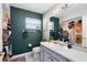 Bathroom with decorative dark green wall and tub with a decorative shower curtain at 2101 Lake Francis Dr, Apopka, FL 32712