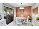 Cozy dining area with a round table, white chairs, and a view of the screened-in patio at 2101 Lake Francis Dr, Apopka, FL 32712