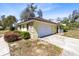 Charming home exterior with a two-car garage, manicured shrubs, and well-maintained landscaping at 2101 Lake Francis Dr, Apopka, FL 32712