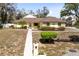 Charming yellow single-story home with stone accents and a well-maintained front yard at 2101 Lake Francis Dr, Apopka, FL 32712