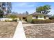 Charming yellow home with stone accents, well-manicured landscaping, and welcoming walkway at 2101 Lake Francis Dr, Apopka, FL 32712