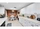 Bright kitchen with white cabinets, modern appliances, and an adjacent dining area at 2101 Lake Francis Dr, Apopka, FL 32712