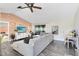 Bright living room featuring a large sectional sofa, ceiling fan, and sliding door access to the lanai at 2101 Lake Francis Dr, Apopka, FL 32712