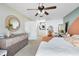 Bright main bedroom with decorative furniture and an ensuite bathroom at 2101 Lake Francis Dr, Apopka, FL 32712