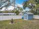 Well-maintained backyard featuring a white fence, storage shed, and a decorative fountain at 212 W 18Th St, Sanford, FL 32771