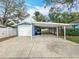 Exterior view of a home with an attached carport and golf cart, offering convenient parking at 212 W 18Th St, Sanford, FL 32771