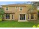 Two-story home with a well-manicured lawn, back patio and mature trees at 2162 Camel Lake Ct, Oviedo, FL 32765