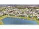 Beautiful aerial view of homes in a lakeside community, showcasing serene water and lush landscaping at 2326 Wintermere Pointe Dr, Winter Garden, FL 34787