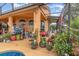 The backyard of the house has many plants, a partial view of the pool, and a screened-in patio at 2326 Wintermere Pointe Dr, Winter Garden, FL 34787