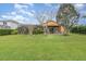 A spacious backyard with mature trees and a well-maintained lawn, offering privacy and shade for outdoor enjoyment at 2326 Wintermere Pointe Dr, Winter Garden, FL 34787