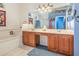 Bathroom features tile floors, double sink vanity with seating area, soaking tub, and separate shower at 2326 Wintermere Pointe Dr, Winter Garden, FL 34787