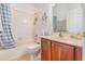 Bathroom featuring a shower with a blue curtain, a white toilet and a wooden sink vanity at 2326 Wintermere Pointe Dr, Winter Garden, FL 34787