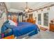 Comfortable bedroom with ceiling fan, gray carpet, glass doors, and wooden furniture at 2326 Wintermere Pointe Dr, Winter Garden, FL 34787