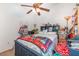 Bedroom featuring a ceiling fan, blue bed frame, a colorful quilt, and shelving unit at 2326 Wintermere Pointe Dr, Winter Garden, FL 34787