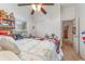 Bedroom featuring a ceiling fan, white closets and a bed with a quilt and an exit to the hallway at 2326 Wintermere Pointe Dr, Winter Garden, FL 34787
