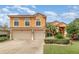 Charming two-story home with a well-manicured lawn and a convenient two-car garage at 2326 Wintermere Pointe Dr, Winter Garden, FL 34787