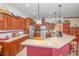 Kitchen with stainless steel appliances, cherry cabinets, and breakfast bar seating at 2326 Wintermere Pointe Dr, Winter Garden, FL 34787