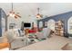 Bright living room featuring vaulted ceilings, ceiling fans, blue accent wall, and carpet at 2326 Wintermere Pointe Dr, Winter Garden, FL 34787