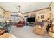 Spacious living room featuring a ceiling fan, arched windows, and comfortable seating at 2326 Wintermere Pointe Dr, Winter Garden, FL 34787