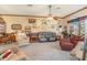 Spacious living room with comfortable seating, carpet, ceiling fan, and decorations at 2326 Wintermere Pointe Dr, Winter Garden, FL 34787