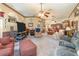 Spacious living room with comfortable seating, carpet, and a ceiling fan at 2326 Wintermere Pointe Dr, Winter Garden, FL 34787