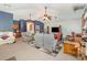 Spacious living room features vaulted ceilings, ceiling fans, blue accent wall, and carpet at 2326 Wintermere Pointe Dr, Winter Garden, FL 34787