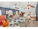 Spacious living room features vaulted ceilings, ceiling fans, blue accent wall, and carpet at 2326 Wintermere Pointe Dr, Winter Garden, FL 34787