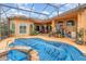 A covered pool with hot tub is covered by a blue tarp and surrounded by potted plants and patio furniture at 2326 Wintermere Pointe Dr, Winter Garden, FL 34787