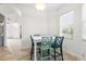 Bright dining room with a white table and colorful chairs next to a bright window at 2333 Pesaro Cir, Ocoee, FL 34761