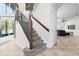 Carpeted staircase with wooden handrail leads to the second floor of a bright, modern home at 2333 Pesaro Cir, Ocoee, FL 34761