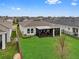 Aerial view of a well-maintained backyard featuring a screened-in porch, a hot tub, and green grass at 2949 Marlberry Ln, Clermont, FL 34714
