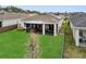 An aerial view of the home's backyard with a screened-in porch and lush lawn at 2949 Marlberry Ln, Clermont, FL 34714