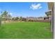 Spacious backyard featuring lush green grass, a fence, and views of the surrounding neighborhood at 2949 Marlberry Ln, Clermont, FL 34714
