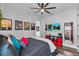 Inviting bedroom with geometric wallpaper, ceiling fan, and an inviting dark-colored bed at 2949 Marlberry Ln, Clermont, FL 34714